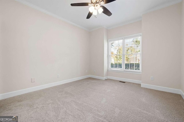 empty room with crown molding, carpet, and ceiling fan