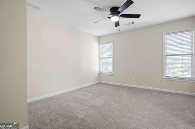 spare room with ceiling fan and carpet floors