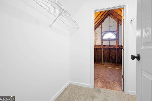 spacious closet with carpet and vaulted ceiling