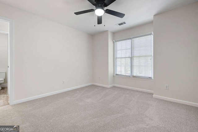 carpeted spare room with ceiling fan