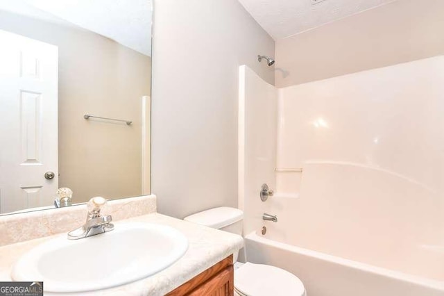 full bathroom featuring bathing tub / shower combination, vanity, and toilet