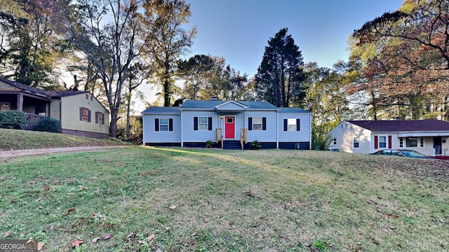 single story home featuring a front lawn