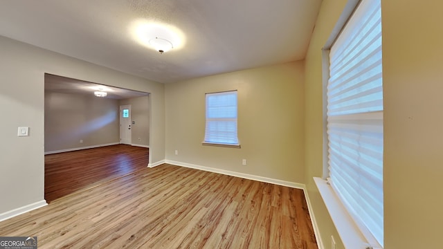 spare room with light hardwood / wood-style flooring