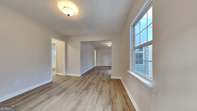 spare room with plenty of natural light and light hardwood / wood-style floors