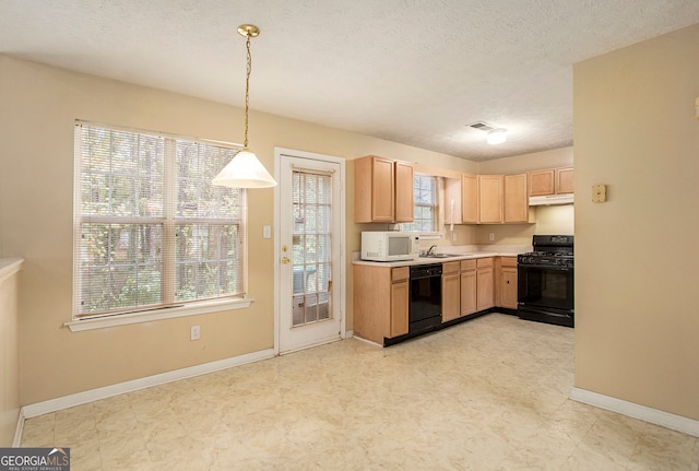 kitchen with black appliances, decorative light fixtures, a textured ceiling, and a wealth of natural light