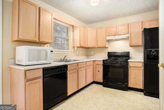 kitchen featuring black appliances, sink, and light brown cabinetry