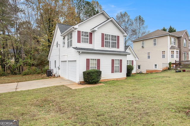 exterior space with central AC unit, a garage, and a front yard