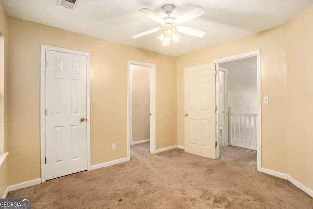 unfurnished bedroom with light carpet and ceiling fan