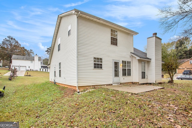 back of house with a yard and a patio