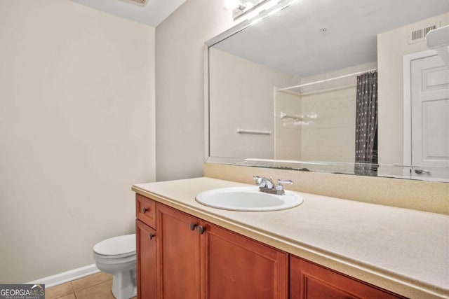 bathroom featuring tile patterned flooring, vanity, curtained shower, and toilet