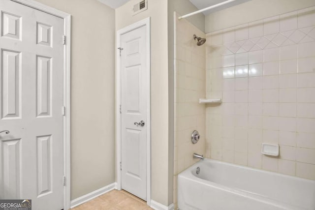 bathroom featuring tile patterned flooring and tiled shower / bath combo