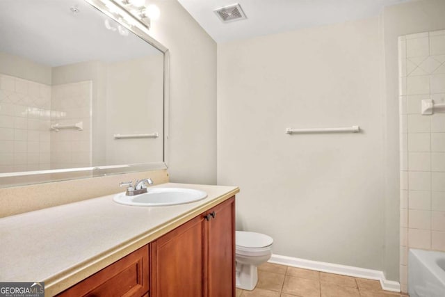 bathroom with tile patterned floors, vanity, and toilet