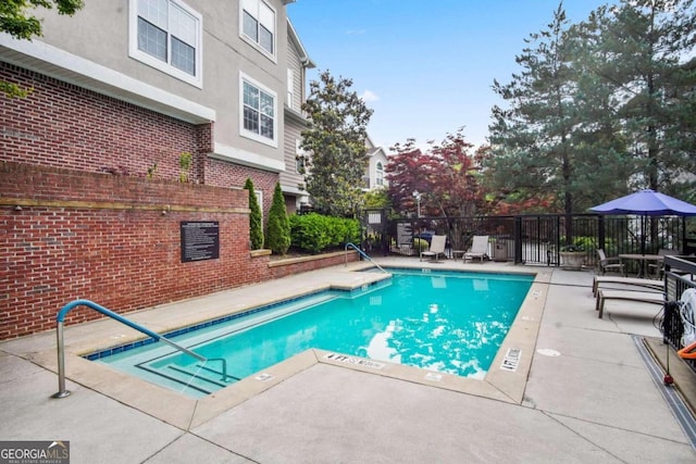 view of swimming pool with a patio area