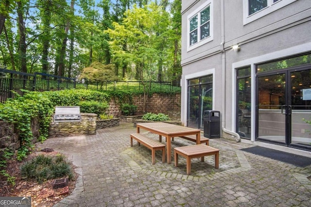 view of patio / terrace featuring an outdoor kitchen and a grill