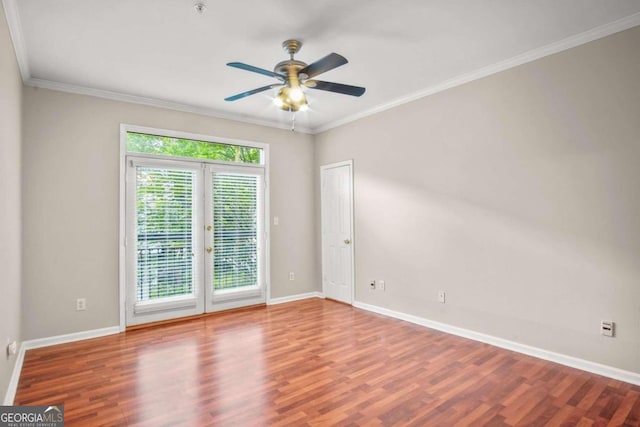 spare room featuring ceiling fan, wood-type flooring, ornamental molding, and french doors