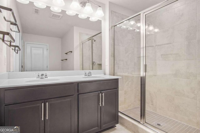 bathroom featuring vanity and a shower with door