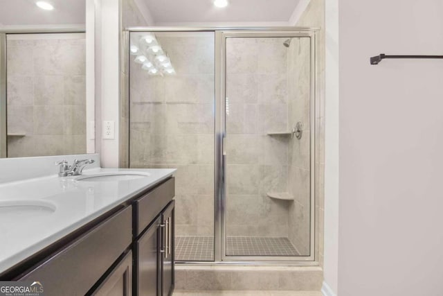 bathroom with a shower with door and vanity