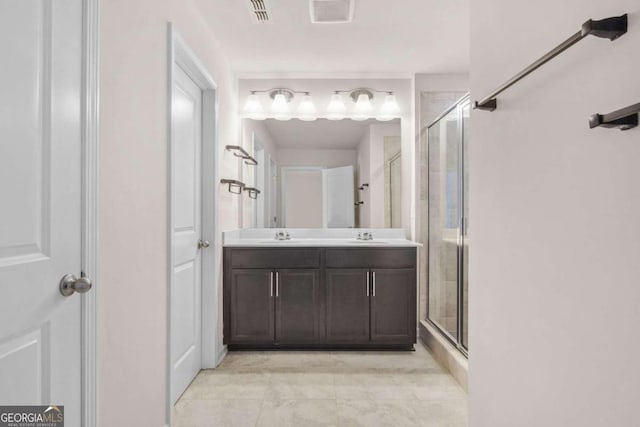 bathroom with vanity and a shower with shower door