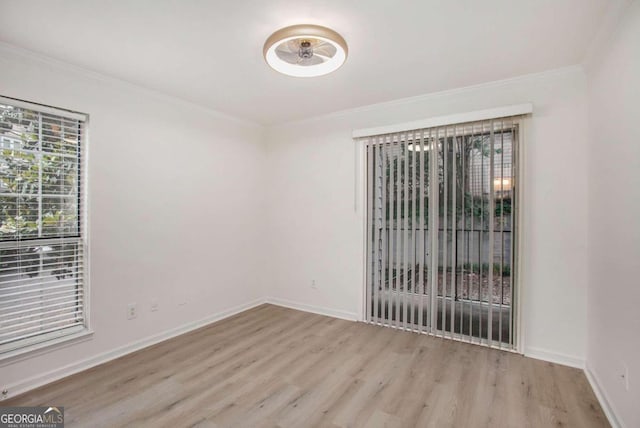 unfurnished room featuring light wood-type flooring and ornamental molding