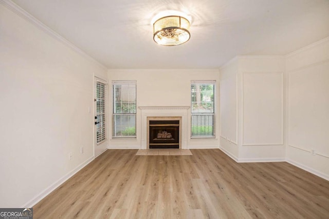 unfurnished living room featuring light hardwood / wood-style floors and ornamental molding