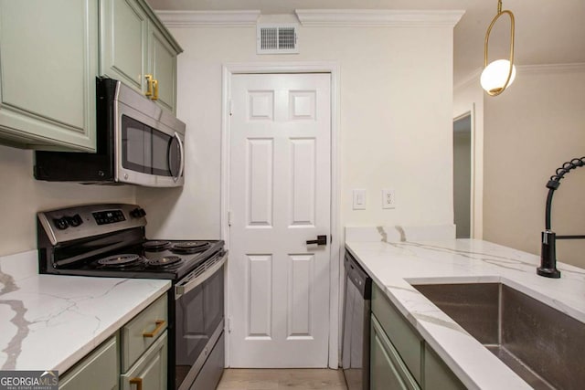 kitchen featuring sink, crown molding, light stone countertops, decorative light fixtures, and stainless steel appliances