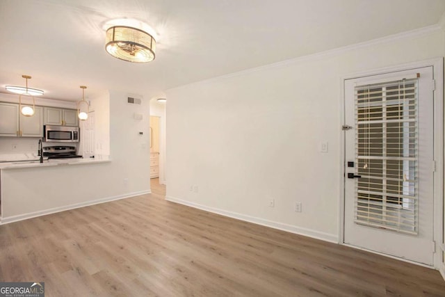 unfurnished living room with crown molding, light hardwood / wood-style flooring, and sink