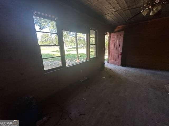 spare room with ceiling fan and a healthy amount of sunlight