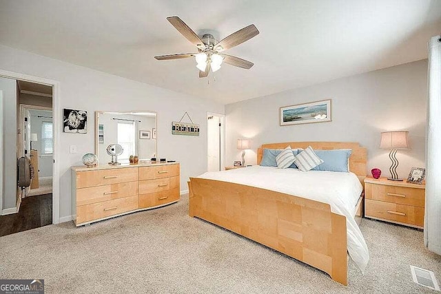 bedroom with ceiling fan and light colored carpet