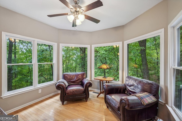 sunroom / solarium with ceiling fan and a healthy amount of sunlight