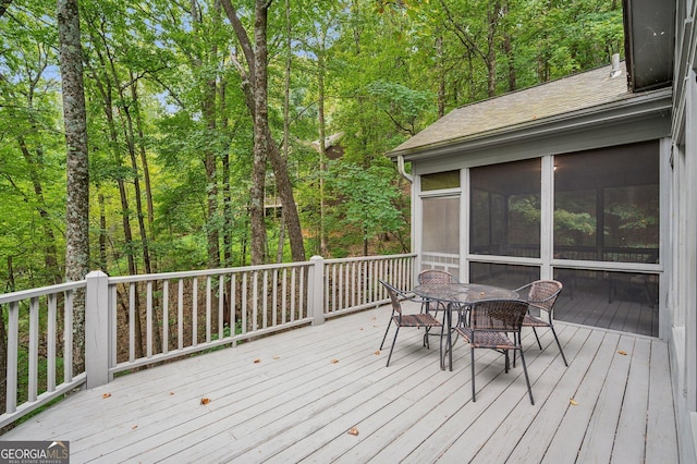 wooden deck with a sunroom