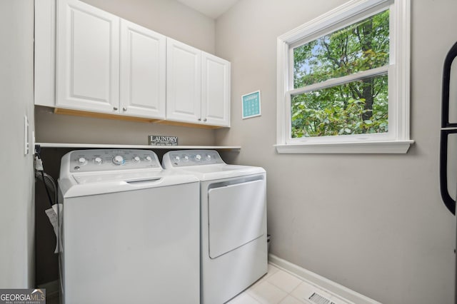 washroom with cabinets and independent washer and dryer