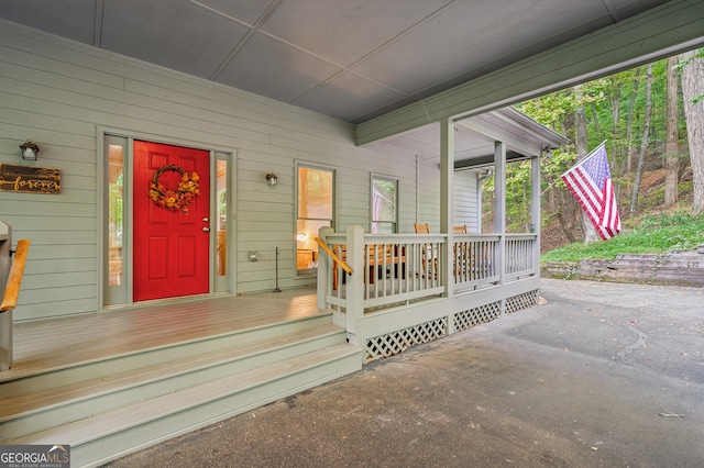 view of exterior entry with covered porch