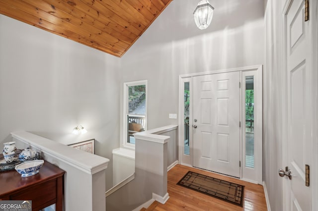 foyer entrance with wooden ceiling, high vaulted ceiling, and light hardwood / wood-style flooring