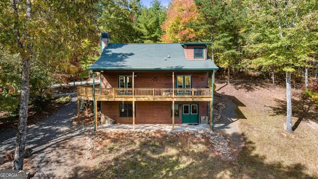 back of house with a patio and a wooden deck