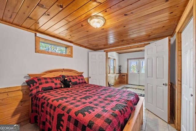 bedroom featuring light tile patterned floors and wood ceiling