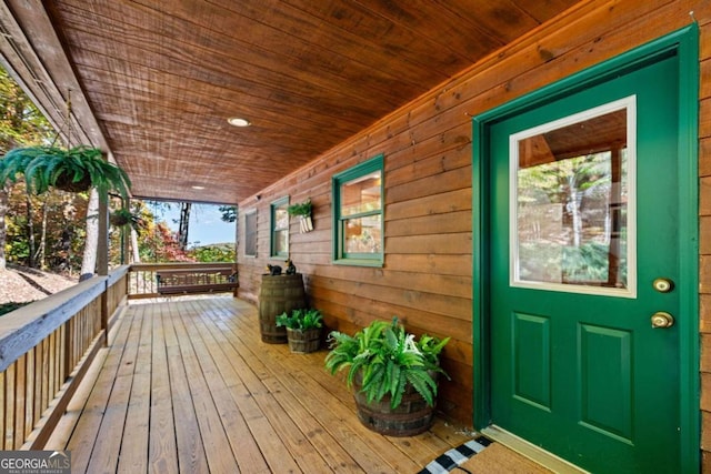 wooden terrace featuring covered porch