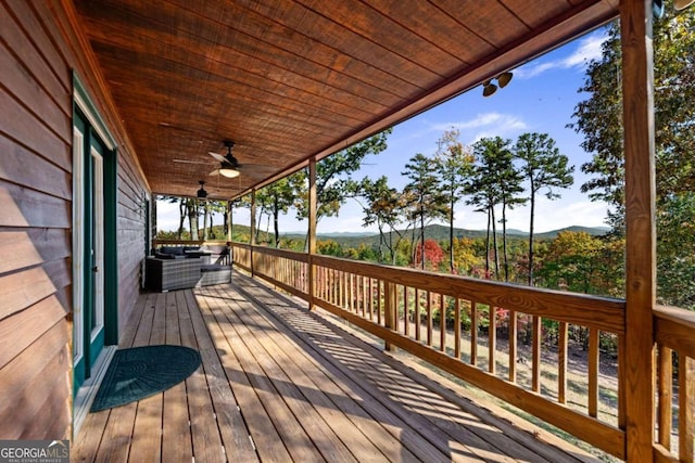 wooden terrace featuring ceiling fan