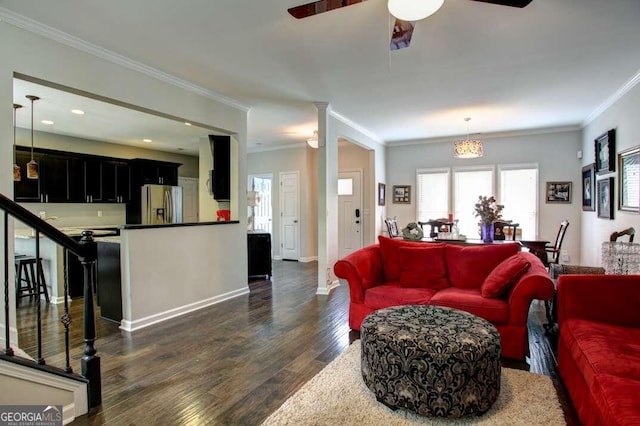 living room featuring ceiling fan, dark hardwood / wood-style flooring, and ornamental molding