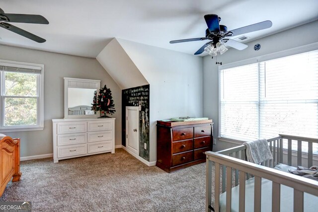 carpeted bedroom with ceiling fan and lofted ceiling