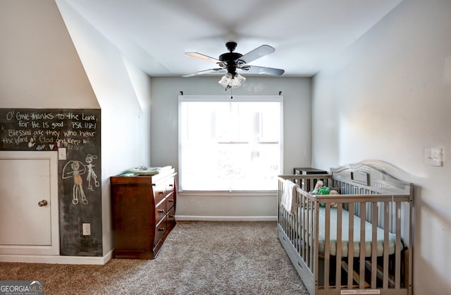 carpeted bedroom with a nursery area and ceiling fan