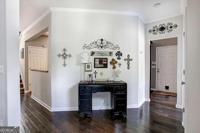 corridor with dark hardwood / wood-style flooring and ornamental molding