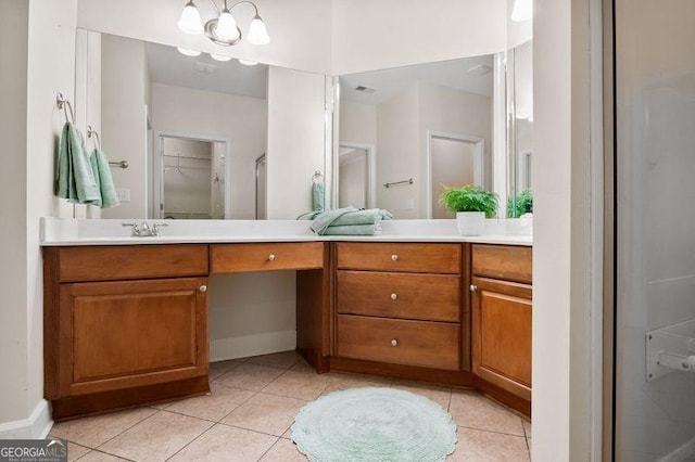 bathroom featuring tile patterned flooring, vanity, and an enclosed shower