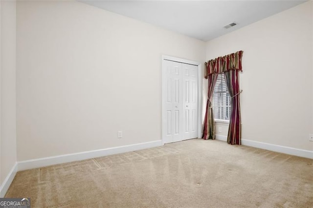 unfurnished room with light colored carpet