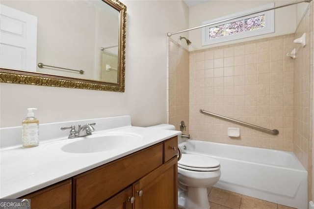 full bathroom with tile patterned flooring, vanity, toilet, and tiled shower / bath