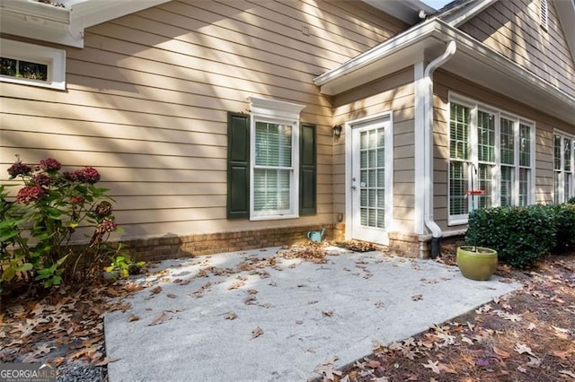 view of property exterior with a patio area