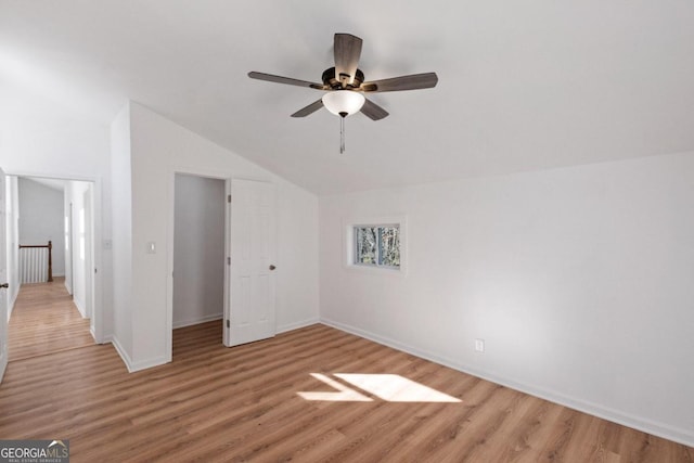 additional living space featuring ceiling fan, vaulted ceiling, and light wood-type flooring