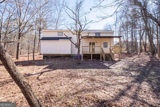 back of house with a wooden deck