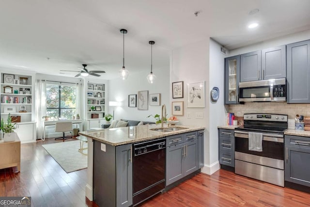 kitchen with gray cabinetry, sink, ceiling fan, appliances with stainless steel finishes, and kitchen peninsula