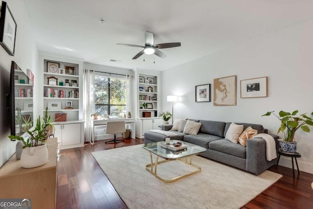 living room with dark hardwood / wood-style floors, ceiling fan, and built in features