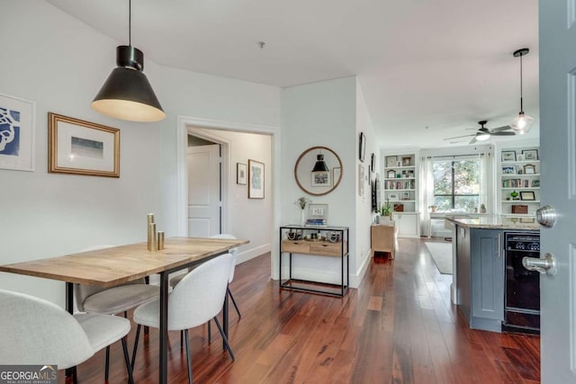 dining area with ceiling fan, beverage cooler, and dark hardwood / wood-style floors